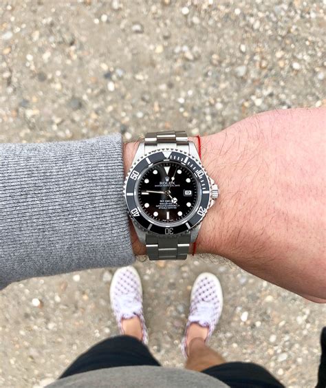 rolex sea dweller on wrist.